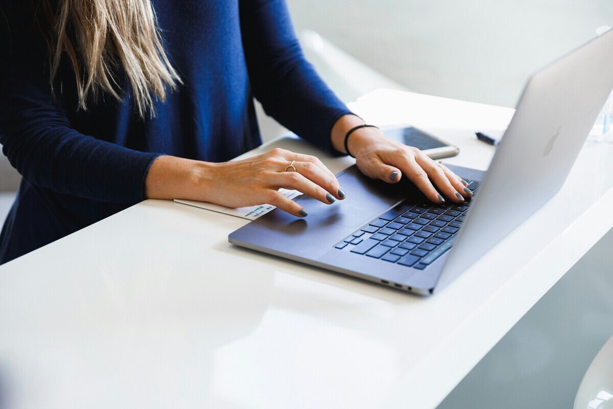 Woman writing better prompts and becoming an AI-Ready HR professional