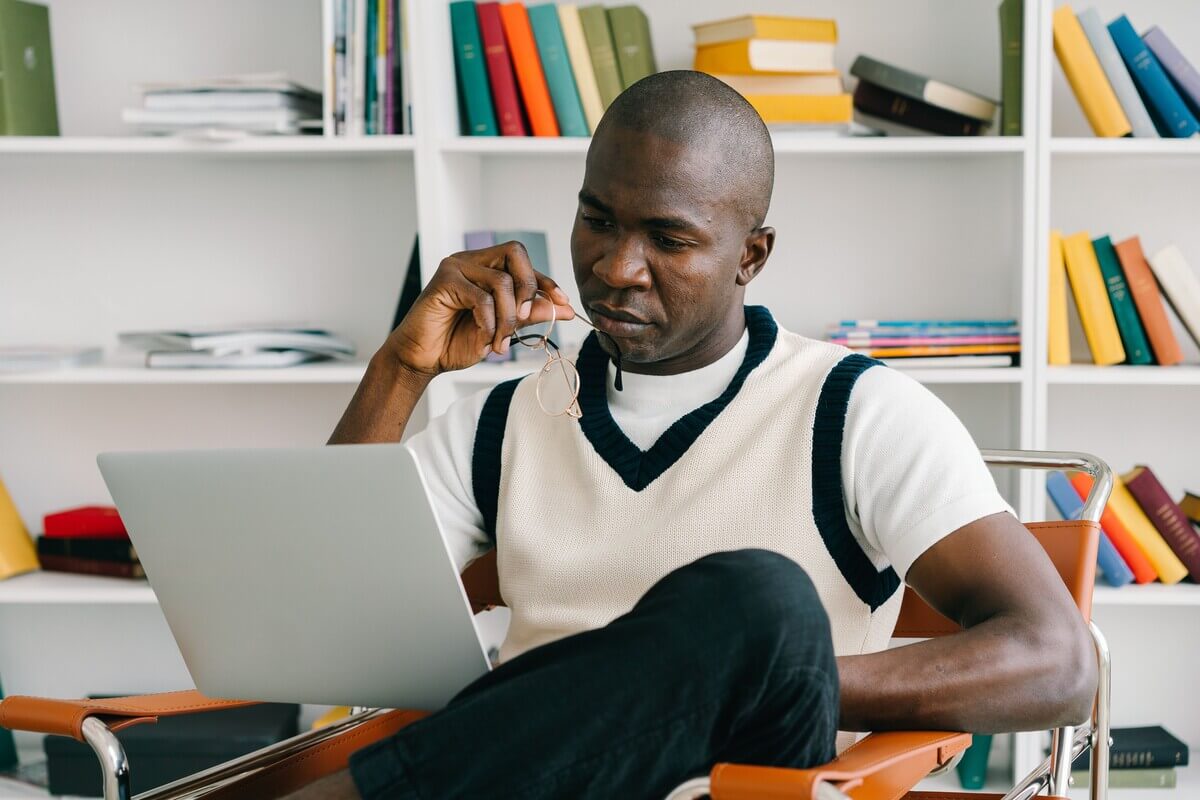Middle age man looking at his computer thinking about returning to study