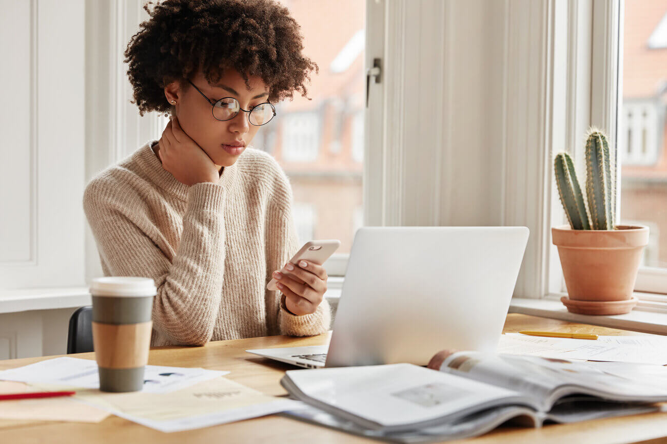 Young, female HR professional sitting alone at her desk