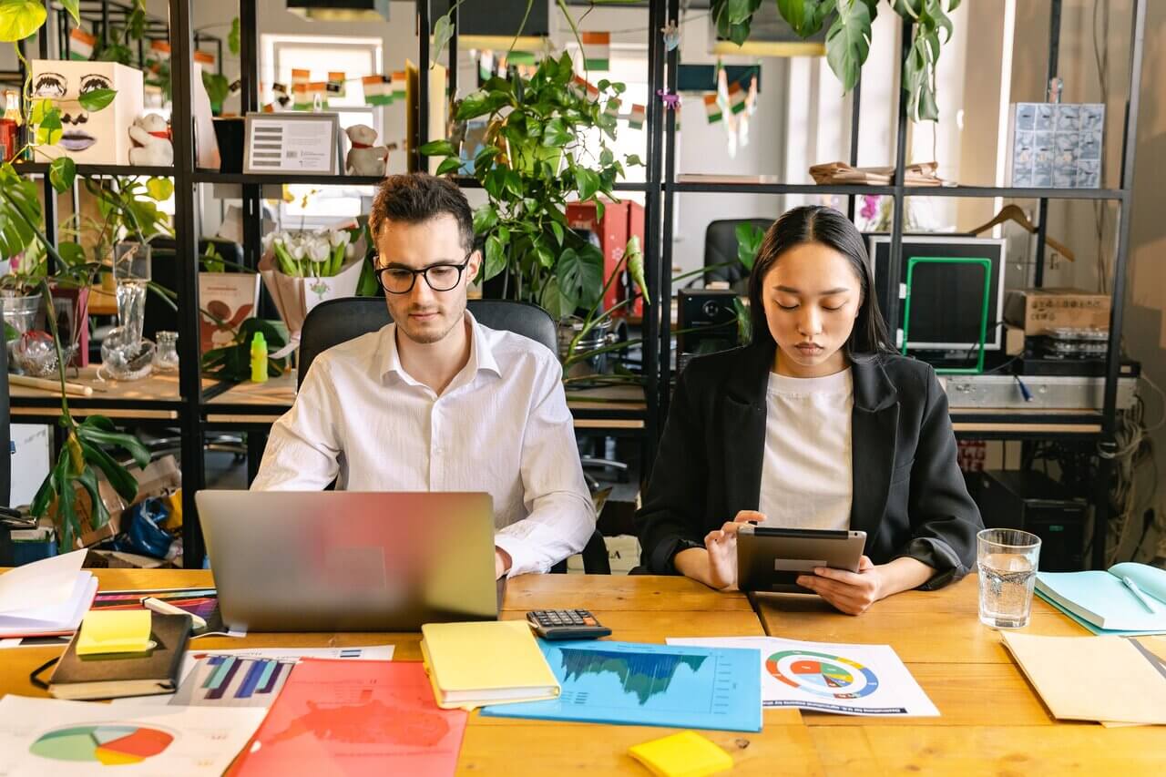 Two colleagues studying how to apply core values in the workplace