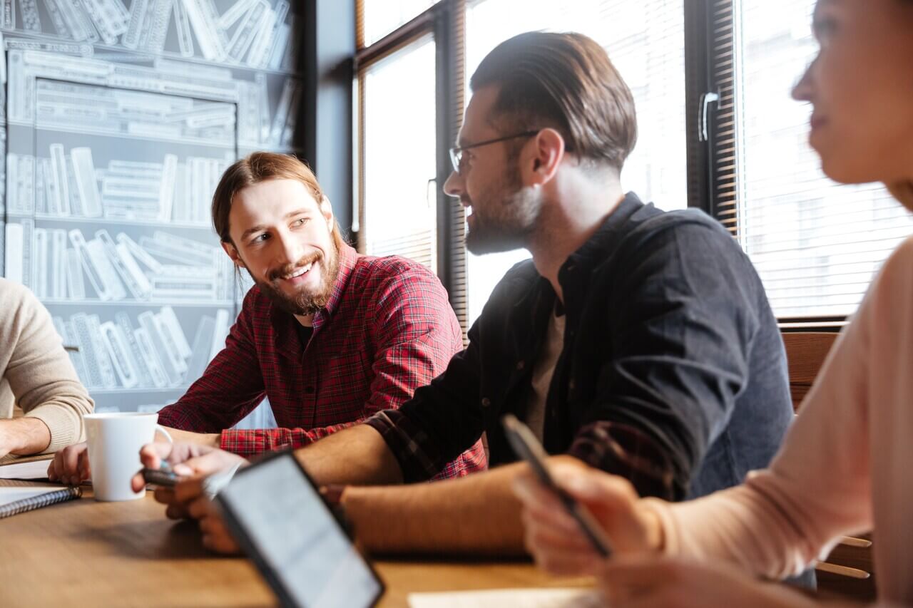 Young HR professionals chatting to each other at a meeting