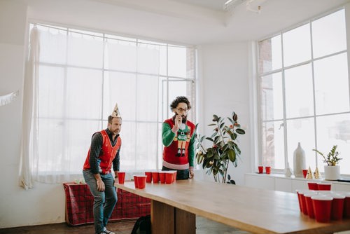 Two employees playing a game at a Christmas party
